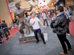 Photo opp with Bruce Lee statue at Chinese New Year Festival in Chinatown L.A., Feb. 17, 2018. Photo by Kevin Bronson